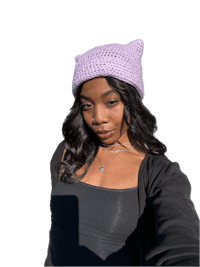 a woman wearing a purple crocheted cat hat
