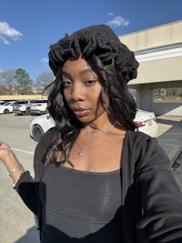 a woman wearing a black hat and jacket